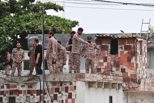 Security personnel inspect the rooftop of a compound at the end of a clearance operation following an alleged explosion and a militant attack in Karachi on June 28, 2026. Heavy gunfire was heard in Pakistan's southern megacity Karachi on June 27 evening, AFP journalists said, following reports of an explosion. (Photo by Asif HASSAN / AFP)