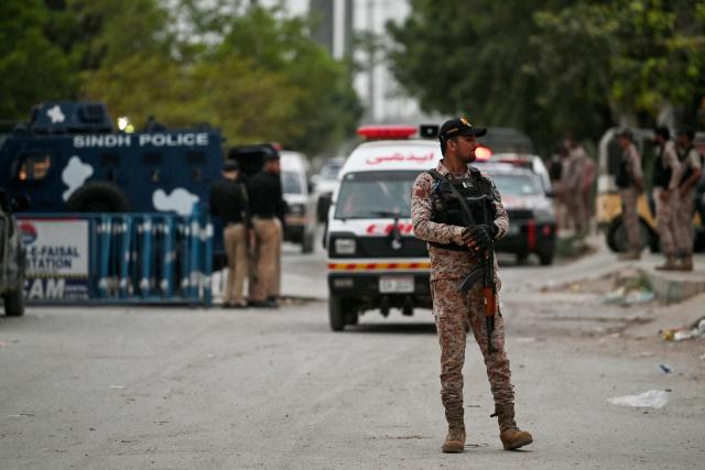 A security personnel stands guard at the end of a clearance operation following an alleged explosion and a militant attack in Karachi on June 28, 2026. Heavy gunfire was heard in Pakistan's southern megacity Karachi on June 27 evening, AFP journalists said, following reports of an explosion. (Photo by Asif HASSAN / AFP)