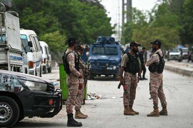 Security personnel stand guard at the end of a clearance operation following an alleged explosion and a militant attack in Karachi on June 28, 2026. Heavy gunfire was heard in Pakistan's southern megacity Karachi on June 27 evening, AFP journalists said, following reports of an explosion. (Photo by Asif HASSAN / AFP)