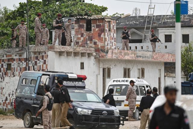 Security personnel inspect the rooftop of a compound at the end of a clearance operation following an alleged explosion and a militant attack in Karachi on June 28, 2026. Heavy gunfire was heard in Pakistan's southern megacity Karachi on June 27 evening, AFP journalists said, following reports of an explosion. (Photo by Asif HASSAN / AFP)