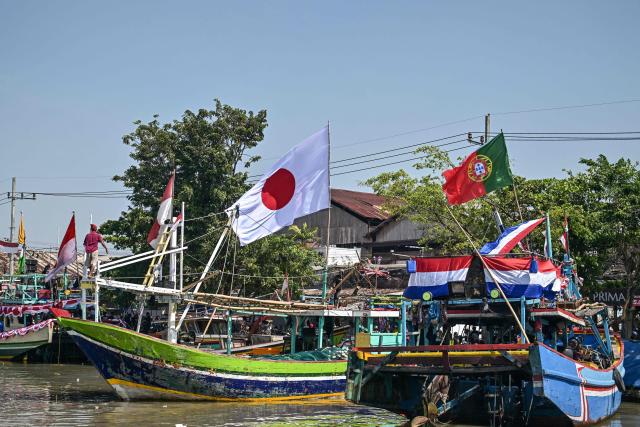 Fishing boats are seen after taking part in the Petik Laut, an annual traditional Javanese thanksgiving ritual during which coastal communities express gratitude for abundant sea harvests, in Pasuruan, East Java province on June 28, 2026. (Photo by Juni KRISWANTO / AFP)