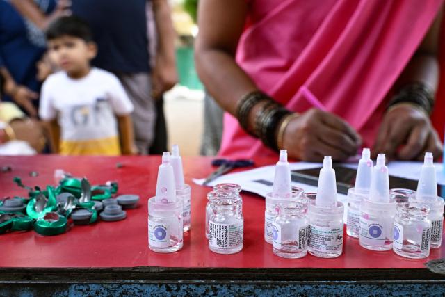 Oral polio vaccine vials are kept on a table during the nationwide Pulse Polio Immunisation Program at a school in Bengaluru on June 28, 2026. (Photo by Idrees MOHAMMED / AFP)