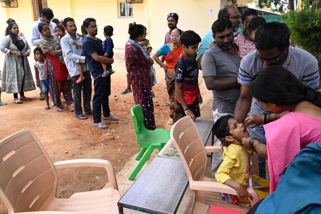 A health worker administers oral polio vaccines to children during the nationwide Pulse Polio Immunisation Program at a school in Bengaluru on June 28, 2026. (Photo by Idrees MOHAMMED / AFP)