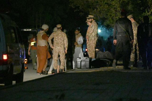 Army soldiers return after completing an operation following a militant attack on Pakistan's Security Rangers compound in Karachi on June 28, 2026. Heavy gunfire was heard in Pakistan's southern megacity Karachi on June 27 evening, according to AFP journalists, following reports of an explosion. (Photo by Rizwan TABASSUM / AFP)
