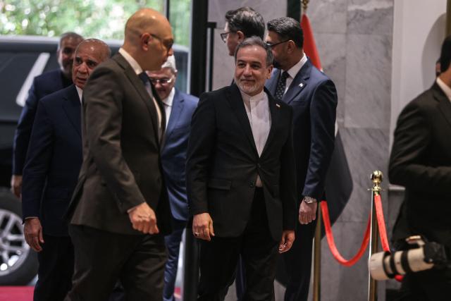 Iranian Foreign Minister Abbas Araqchi (C) looks over upon his arrival for a meeting with his Iraqi counterpart in Baghdad on July 28, 2026. Iran said on June 28, it was determined to defend its sovereignty after the latest US strikes on the country, as a fragile truce in the Middle East war hung in the balance. (Photo by AHMAD AL-RUBAYE / AFP)