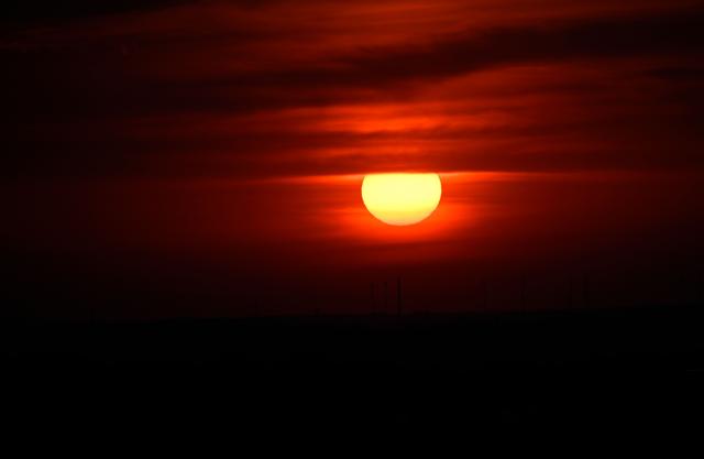 The sun goes up on early June 28, 2026, over the Drachenberg mountain in Berlin, as the German capital is expected to reach teperatures around 40 degrees Celsius during a heatwave in Europe. Tens of millions are braving a weekend of extreme temperatures in Europe as a deadly heatwave moves eastwards, with some countries announcing rising death tolls and health services warning of saturation. While some mild relief is expected Sunday in western Europe, German forecasters are warning that more temperature records could still be broken over the weekend as eastern countries issue a slew of red alerts for the coming days. (Photo by RALF HIRSCHBERGER / AFP)