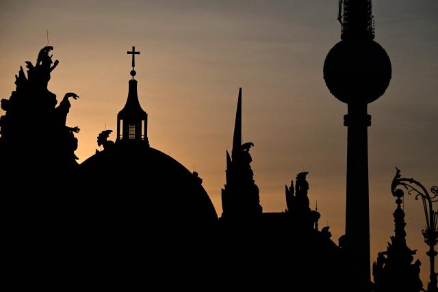 Berlin's landmark TV tower and the cathedral are silhouetted on early June 28, 2026, in Berlin, as the German capital is expected to reach teperatures around 40 degrees Celsius during a heatwave in Europe. Tens of millions are braving a weekend of extreme temperatures in Europe as a deadly heatwave moves eastwards, with some countries announcing rising death tolls and health services warning of saturation. While some mild relief is expected Sunday in western Europe, German forecasters are warning that more temperature records could still be broken over the weekend as eastern countries issue a slew of red alerts for the coming days. (Photo by RALF HIRSCHBERGER / AFP)