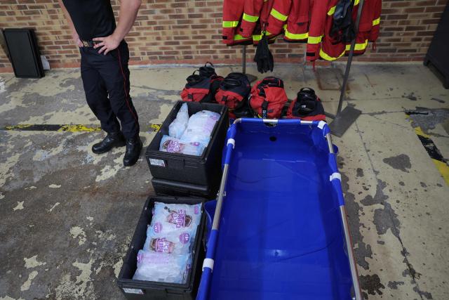 A photo shows an emergency cooling bath and packs of glass during a visit by France's Interior Minister at a fire station to review the crisis management response to the heat wave in Paris on June 28, 2026. (Photo by Kenzo TRIBOUILLARD / AFP)