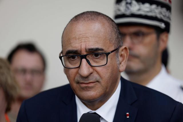 France's Interior Minister Laurent Nunez speaks to the press during his visit to a fire station to review the crisis management response to the heat wave in Paris on June 28, 2026. (Photo by Kenzo TRIBOUILLARD / AFP)