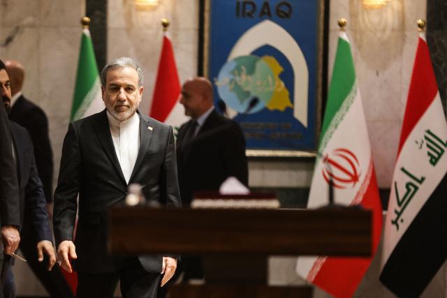 Iranian Foreign Minister Abbas Araqchi walks up to the lecturn to give a press conference with his Iraqi counterpart in Baghdad on July 28, 2026. Iran's foreign minister warned on June 28, that any challenge to the country's control of the strategic Strait of Hormuz would increase tensions despite ongoing peace negotiations to end the Middle East war. (Photo by AHMAD AL-RUBAYE / AFP)