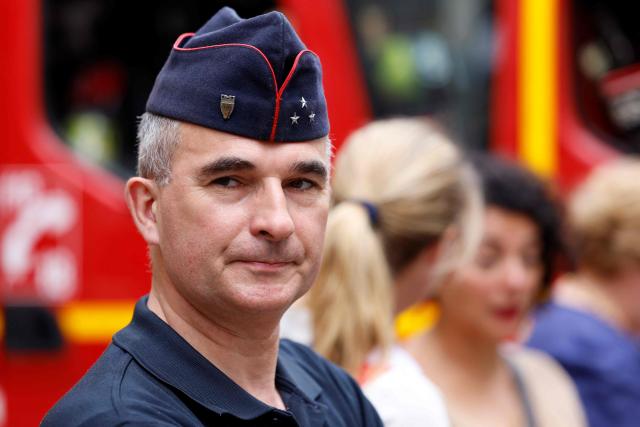 General Arnaud de Cacqueray, head of the Paris Fire Department (BSPP), looks on during a visit by France's Interior Minister to a fire station to review the crisis management response to the heat wave in Paris on June 28, 2026. (Photo by Kenzo TRIBOUILLARD / AFP)