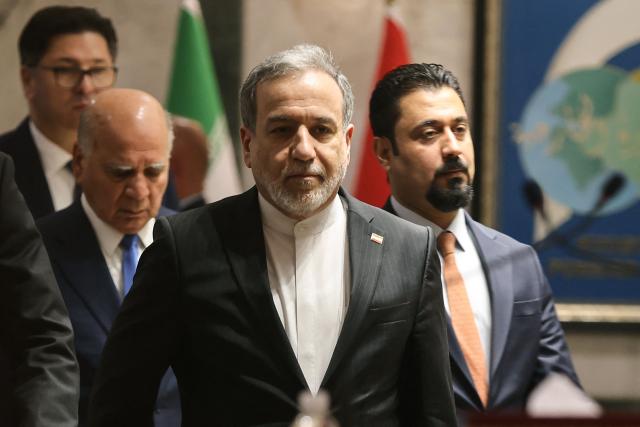 Iranian Foreign Minister Abbas Araqchi (C) followed by Iraqi Foreign Minister Fuad (L) arrive for a joint press conference following a meeting in Baghdad on July 28, 2026. Iran's foreign minister called on June 28, for the establishment of a security framework with Gulf countries, after Iranian strikes against US bases in the Gulf in retaliation for American attacks. (Photo by AHMAD AL-RUBAYE / AFP)