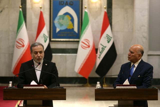 Iranian Foreign Minister Abbas Araqchi (L) listens to Iraqi Foreign Minister Fuad as they hold a joint press conference following a meeting in Baghdad on July 28, 2026. Iran's foreign minister called on June 28, for the establishment of a security framework with Gulf countries, after Iranian strikes against US bases in the Gulf in retaliation for American attacks. (Photo by AHMAD AL-RUBAYE / AFP)