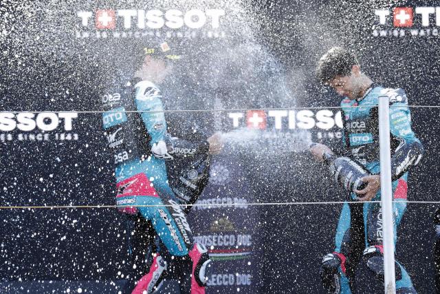 Winner, KTM's Spanish rider Maximo Quiles (L), next to third-placed CFMOTO Gaviota Aspar Team's Argentina's rider Marco Morelli (R), celebrates his victory on the podium in the Moto3 race during the 95th edition of the Dutch Motorcycle Grand Prix at the TT Circuit Assen, in Assen, on June 28, 2026. (Photo by Vincent Jannink / ANP / AFP) / Netherlands OUT