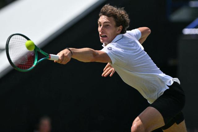 France's Ugo Humbert hits a return against Belgium's Zizou Bergs during their men's final tennis match on day seven of the Lexus Eastbourne Open at Devonshire Park, Eastbourne, on the south coast of England on June 28, 2026. (Photo by Glyn KIRK / AFP)