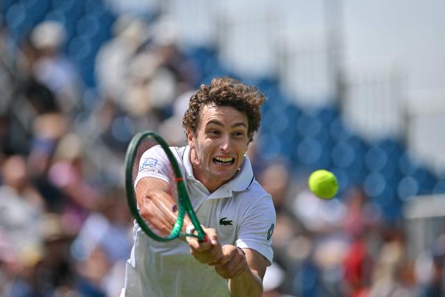 France's Ugo Humbert hits a return against Belgium's Zizou Bergs during their men's final tennis match on day seven of the Lexus Eastbourne Open at Devonshire Park, Eastbourne, on the south coast of England on June 28, 2026. (Photo by Glyn KIRK / AFP)
