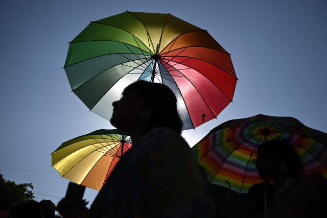 Gender rights activists and supporters of the LGBTQ community hold umbrellas of rainbow colours as they take part in a Pride March in Chennai on June 28, 2026. (Photo by R.Satish BABU / AFP)