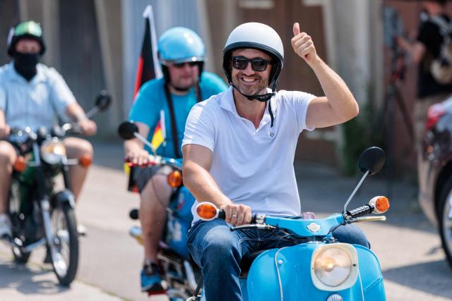 The far-right Alternative for Germany (AfD) party's top candidate for the regional elections in Saxony-Anhalt, Ulrich Siegmund drives a moped as he takes part in an election campaign event and a motorbike and moped ride in Jessnitz, eastern Germany on June 28, 2026. On September 6, 2026, The eastern German state of Saxony-Anhalt will elect a new state parliament. (Photo by Jens SCHLÜTER / AFP)