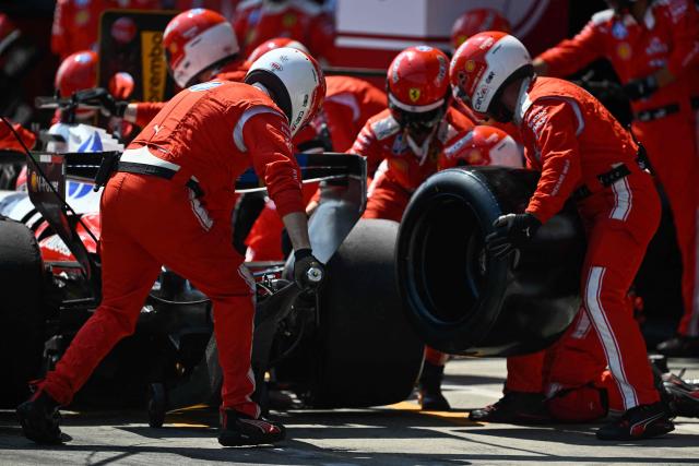 Ferrari mechanics change the tires on Monegasque driver Charles Leclerc's car during the Formula One Austrian Grand Prix at the Red Bull Ring race track in Spielberg, Austria on June 28, 2026. (Photo by Darko BANDIC / POOL / AFP)