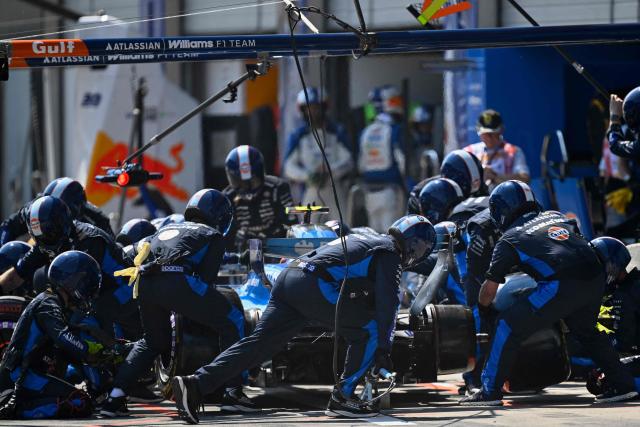 Williams mechanics change the tires on Williams' Spanish driver Carlos Sainz' car during the Formula One Austrian Grand Prix at the Red Bull Ring race track in Spielberg, Austria on June 28, 2026. (Photo by Darko BANDIC / POOL / AFP)