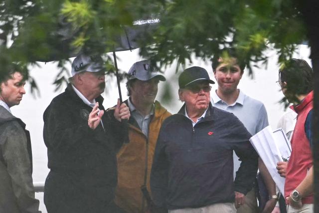 (L/R) US President Donald Trump speaks with Interior Secretary Doug Burgum and golf course architect Tom Fazio as they stand near Ohio Drive next to East Potomac Golf Links in Washington, DC, on June 28, 2026. (Photo by Kent NISHIMURA / AFP)