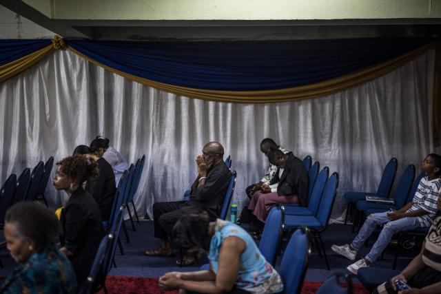 Worshippers join a crowd of both South African and foreign congregants as they gather to pray at the Supernatural Platform Global Ministries church of pastors Professor Vivian Besem Ojong and John Arinze, both of Nigerian origin, in Durban, on June 28, 2026. South Africans President Cyril Ramaphosa vowed on Thursday to crush any attempts to destabilise the nation during planned anti-immigrant marches next week, amid a wave of xenophobia. Citizen-led groups have set Tuesday 30 as a deadline for undocumented foreigners to leave and called for nationwide marches against illegal immigration, marking a crescendo in months of protests that have at times turned violent. (Photo by MARCO LONGARI / AFP)