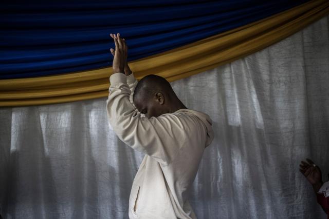 Worshippers join a crowd of both South African and foreign congregants as they gather to pray at the Supernatural Platform Global Ministries church of pastors Professor Vivian Besem Ojong and John Arinze, both of Nigerian origin, in Durban, on June 28, 2026. South Africans President Cyril Ramaphosa vowed on Thursday to crush any attempts to destabilise the nation during planned anti-immigrant marches next week, amid a wave of xenophobia. Citizen-led groups have set Tuesday 30 as a deadline for undocumented foreigners to leave and called for nationwide marches against illegal immigration, marking a crescendo in months of protests that have at times turned violent. (Photo by MARCO LONGARI / AFP)