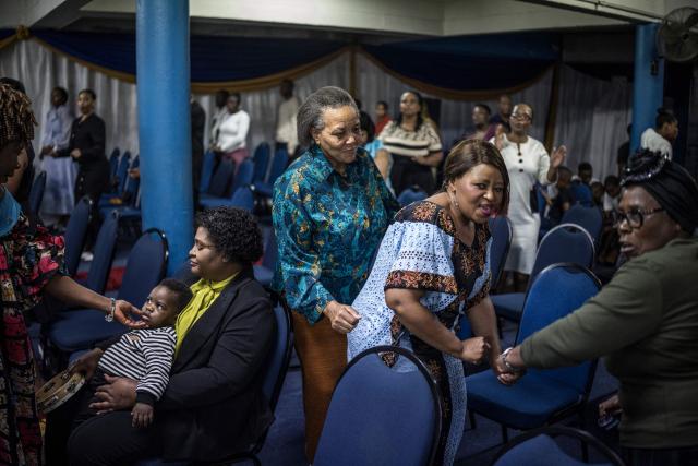 Worshippers join a crowd of both South African and foreign congregants as they gather to pray at the Supernatural Platform Global Ministries church of pastors Professor Vivian Besem Ojong and John Arinze, both of Nigerian origin, in Durban, on June 28, 2026. South Africans President Cyril Ramaphosa vowed on Thursday to crush any attempts to destabilise the nation during planned anti-immigrant marches next week, amid a wave of xenophobia. Citizen-led groups have set Tuesday 30 as a deadline for undocumented foreigners to leave and called for nationwide marches against illegal immigration, marking a crescendo in months of protests that have at times turned violent. (Photo by MARCO LONGARI / AFP)