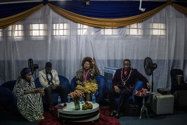 Pastors Professor Vivian Besem Ojong (2nd R) and John Arinze (R), both of Nigerian origin, lead a crowd of both South African and foreign congregants as they gather to pray at the Supernatural Platform Global Ministries church in Durban, on June 28, 2026. South Africans President Cyril Ramaphosa vowed on Thursday to crush any attempts to destabilise the nation during planned anti-immigrant marches next week, amid a wave of xenophobia. Citizen-led groups have set Tuesday 30 as a deadline for undocumented foreigners to leave and called for nationwide marches against illegal immigration, marking a crescendo in months of protests that have at times turned violent. (Photo by MARCO LONGARI / AFP)