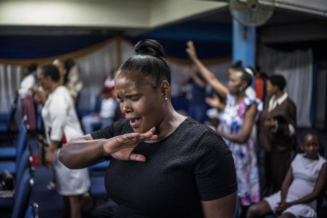 Worshippers join a crowd of both South African and foreign congregants as they gather to pray at the Supernatural Platform Global Ministries church of pastors Professor Vivian Besem Ojong and John Arinze, both of Nigerian origin, in Durban, on June 28, 2026. South Africans President Cyril Ramaphosa vowed on Thursday to crush any attempts to destabilise the nation during planned anti-immigrant marches next week, amid a wave of xenophobia. Citizen-led groups have set Tuesday 30 as a deadline for undocumented foreigners to leave and called for nationwide marches against illegal immigration, marking a crescendo in months of protests that have at times turned violent. (Photo by MARCO LONGARI / AFP)