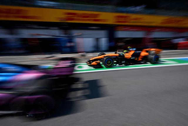 McLaren's British driver Lando Norris (R) comes in to the pit lane as Alpine's Argentine driver Franco Colapinto drives past during the Formula One Austrian Grand Prix at the Red Bull Ring race track in Spielberg, Austria on June 28, 2026. (Photo by Darko BANDIC / POOL / AFP)