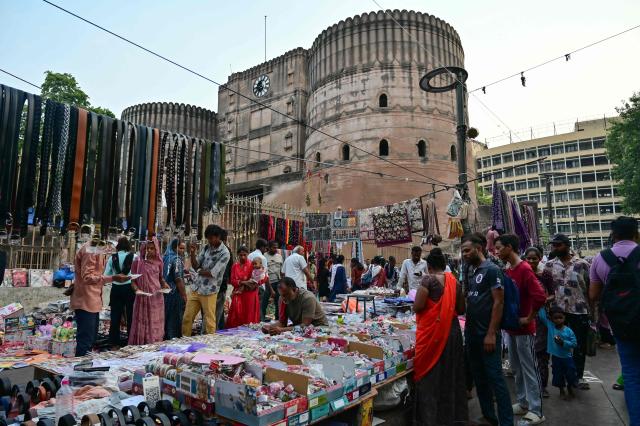 People shop at a Sunday market near the Bhadra Fort in Ahmedabad on June 28, 2026. (Photo by Shammi MEHRA / AFP)
