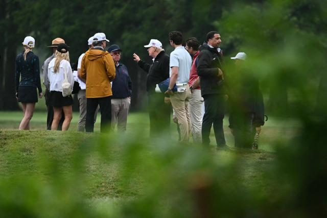 US President Donald Trump speaks with golf course architect Tom Fazio (center L), Interior Secretary Doug Burgum and others at East Potomac Golf Links in Washington, DC, on June 28, 2026. (Photo by Kent NISHIMURA / AFP)