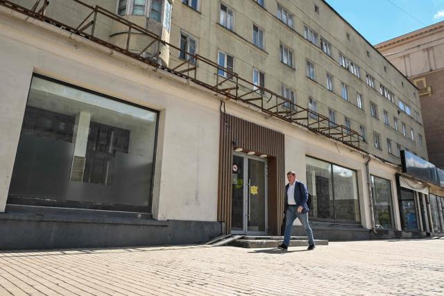 A man walks past the empty display windows of closed shops in Moscow on June 28, 2026. (Photo by Igor IVANKO / AFP)