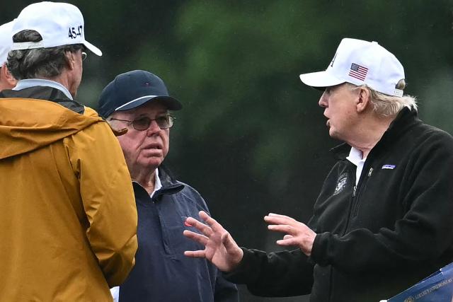 US President Donald Trump speaks with golf course architect Tom Fazio (2L) and Interior Secretary Doug Burgum (L) at East Potomac Golf Links in Washington, DC, on June 28, 2026. (Photo by Kent NISHIMURA / AFP)