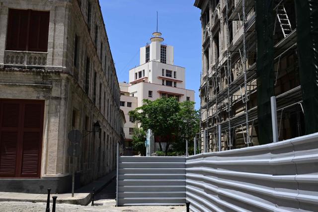 The headquarters building of GAESA (Grupo de Administracion Empresarial S.A.) is seen in the background in Havana on June 27, 2026. Cuba's sanctioned military conglomerate GAESA, which controls much of the island's economy, has spun off its port management business seeking to unlock stalled foreign supplies, several industry sources told AFP on June 26. (Photo by Pablo PORCIUNCULA / AFP)