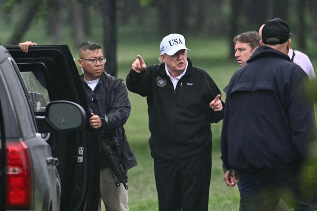 US President Donald Trump gestures as he stands near his motorcade after making a visit to East Potomac Golf Links in Washington, DC, on June 28, 2026. (Photo by Kent NISHIMURA / AFP)