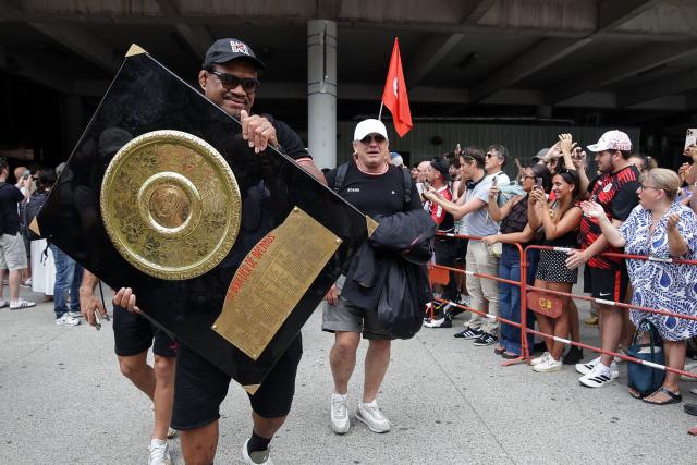 Former Toulouse's Samoan lock Iosefa Tekori (L) holds the "Bouclier de Brennus" trophy next to Stade Toulousain's French president Didier Lacroix (C) as Stade Toulousain's players celebrate with supporters a day after winning the French Top 14 rugby union championship, on the forecourt of Matabiau station in Toulouse, southwestern France, on June 28, 2026. (Photo by Valentine CHAPUIS / AFP)