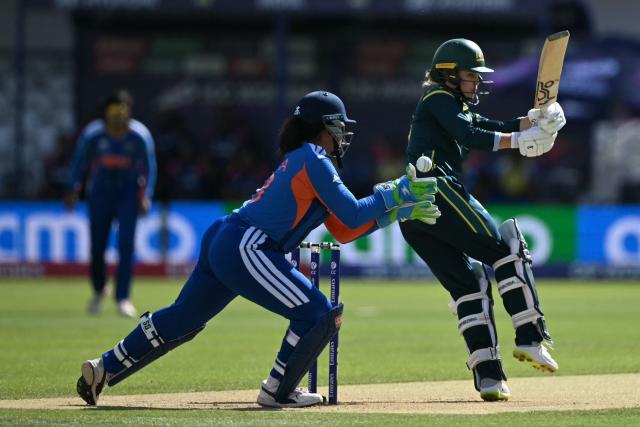 Australia's Phoebe Litchfield plays a shot past India's wicket keeper Richa Ghosh during the ICC Women's T20 cricket world cup 2026 game between Australia and India, at Lord's in London on June 28, 2026. (Photo by JUSTIN TALLIS / AFP)