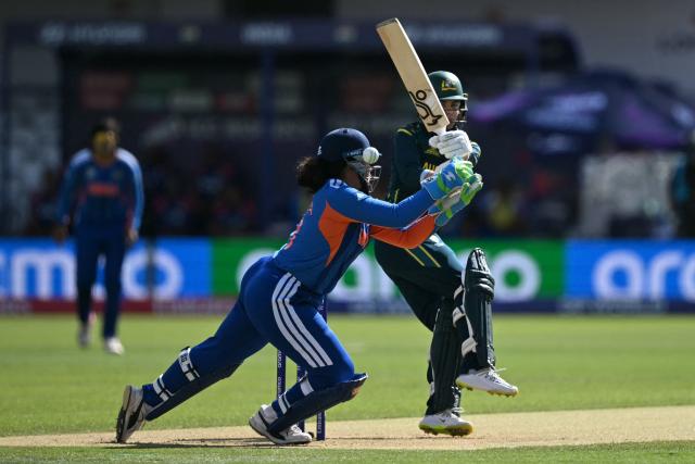 Australia's Phoebe Litchfield plays a shot past India's wicket keeper Richa Ghosh during the ICC Women's T20 cricket world cup 2026 game between Australia and India, at Lord's in London on June 28, 2026. (Photo by JUSTIN TALLIS / AFP)
