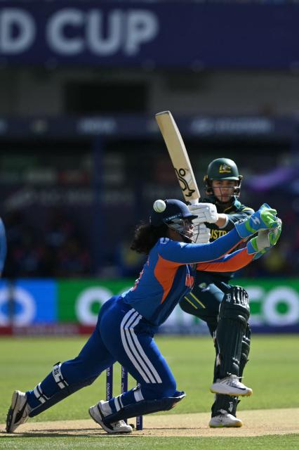 Australia's Phoebe Litchfield plays a shot past India's wicket keeper Richa Ghosh during the ICC Women's T20 cricket world cup 2026 game between Australia and India, at Lord's in London on June 28, 2026. (Photo by JUSTIN TALLIS / AFP)