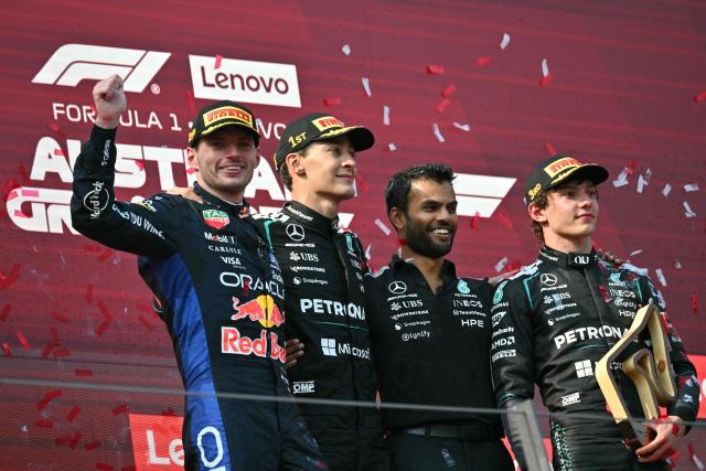 (L-R) Second placed Red Bull Racing's Dutch driver Max Verstappen, winner Mercedes' British driver George Russell, a Mercedes teammember and third placed Mercedes' Italian driver Kimi Antonelli celebrate on the podium after the Formula One Austrian Grand Prix at the Red Bull Ring race track in Spielberg, Austria on June 28, 2026. (Photo by Andrej ISAKOVIC / AFP)