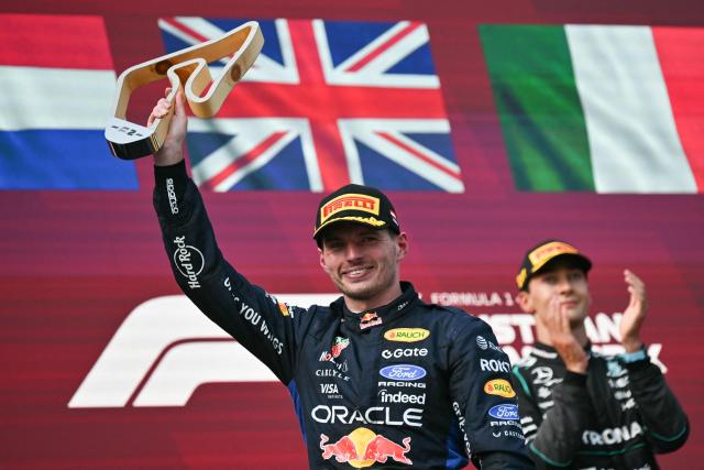 Second placed Red Bull Racing's Dutch driver Max Verstappen celebrates with his trophy next to winner Mercedes' British driver George Russell (R) on the podium after the Formula One Austrian Grand Prix at the Red Bull Ring race track in Spielberg, Austria on June 28, 2026. (Photo by Andrej ISAKOVIC / AFP)
