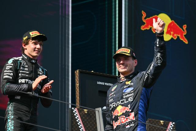 Second placed Red Bull Racing's Dutch driver Max Verstappen (R) arrives on the podium next to third placed Mercedes' Italian driver Kimi Antonelli after the Formula One Austrian Grand Prix at the Red Bull Ring race track in Spielberg, Austria on June 28, 2026. (Photo by Andrej ISAKOVIC / AFP)