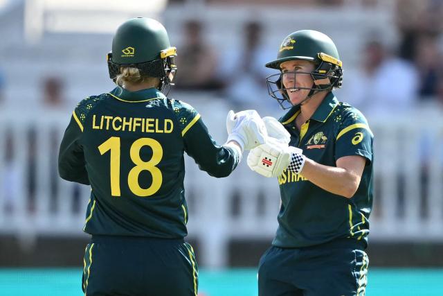 Australia's Phoebe Litchfield and Australia's Beth Mooney touch gloves as they build their partnership during the ICC Women's T20 cricket world cup 2026 game between Australia and India, at Lord's in London on June 28, 2026. (Photo by JUSTIN TALLIS / AFP)