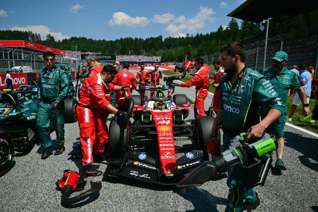 Mechanics work on the car of Ferrari's British driver Lewis Hamilton prior to the Formula One Austrian Grand Prix at the Red Bull Ring race track in Spielberg, Austria on June 28, 2026. (Photo by Andrej ISAKOVIC / AFP)