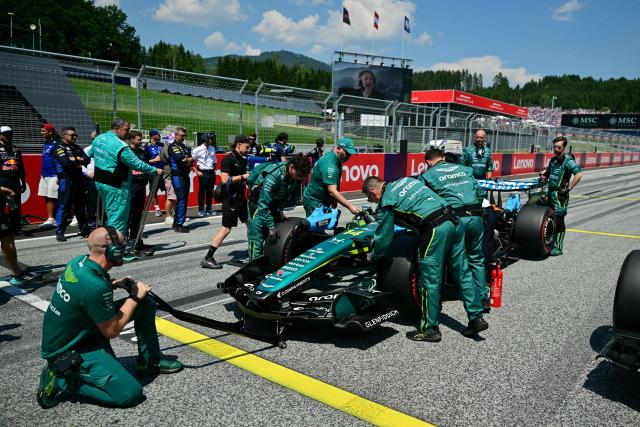 Mechanics work on the car of Aston Martin's Spanish driver Fernando Alonso prior to the Formula One Austrian Grand Prix at the Red Bull Ring race track in Spielberg, Austria on June 28, 2026. (Photo by Andrej ISAKOVIC / AFP)