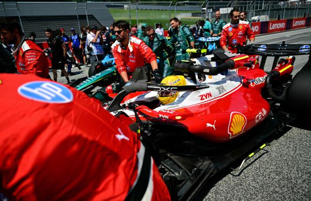 Mechanics move the car with Ferrari's British driver Lewis Hamilton prior to the Formula One Austrian Grand Prix at the Red Bull Ring race track in Spielberg, Austria on June 28, 2026. (Photo by Andrej ISAKOVIC / AFP)