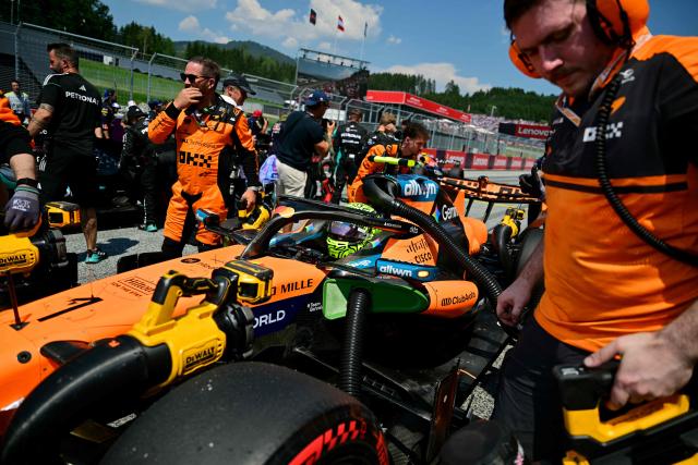 Mechanics work on the car of McLaren's British driver Lando Norris prior to the Formula One Austrian Grand Prix at the Red Bull Ring race track in Spielberg, Austria on June 28, 2026. (Photo by Andrej ISAKOVIC / AFP)