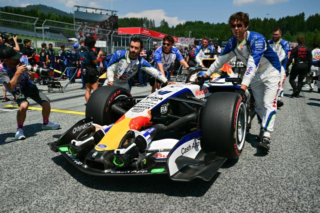 Mechanics move the car of Racing Bulls' British driver Arvid Lindblad prior to the Formula One Austrian Grand Prix at the Red Bull Ring race track in Spielberg, Austria on June 28, 2026. (Photo by Andrej ISAKOVIC / AFP)